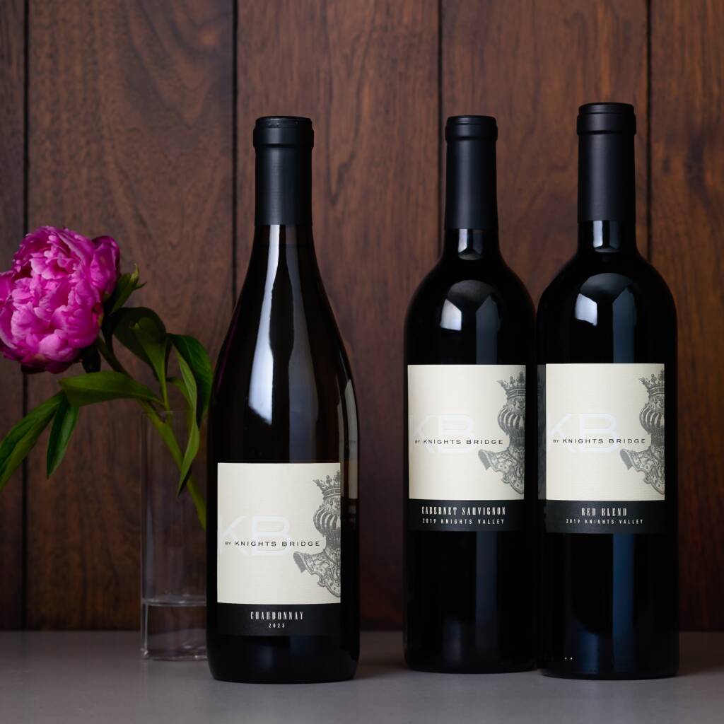 Array of KB by Knights Bridge red wines with pink peony.