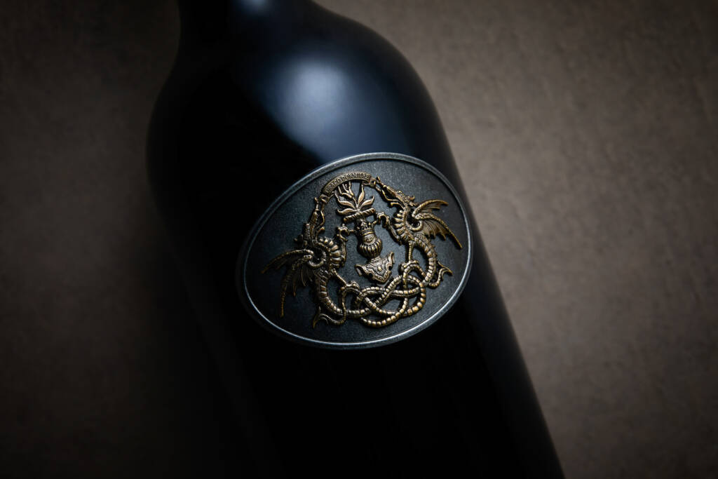 Single Draco bottle, close-up of metalwork label.