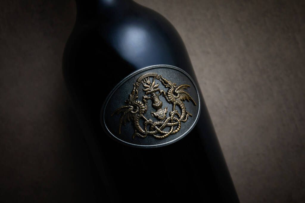 Single Draco bottle, close-up of metalwork label.