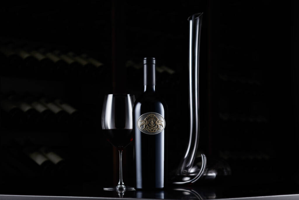 750ml Draco Dormiere bottle in wine cellar with tall-necked decanter.